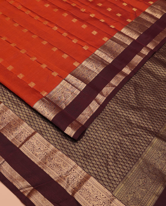 Rust Orange Vasundhara Lite-Silk Mix Saree Showcasing Mayil Buttas, Complemented with a Contrast Rettai Pettu Border Featuring Muthu, Diamond, and Mayil Designs, Adorned with Jaal Pallu, and a Contrast Blouse