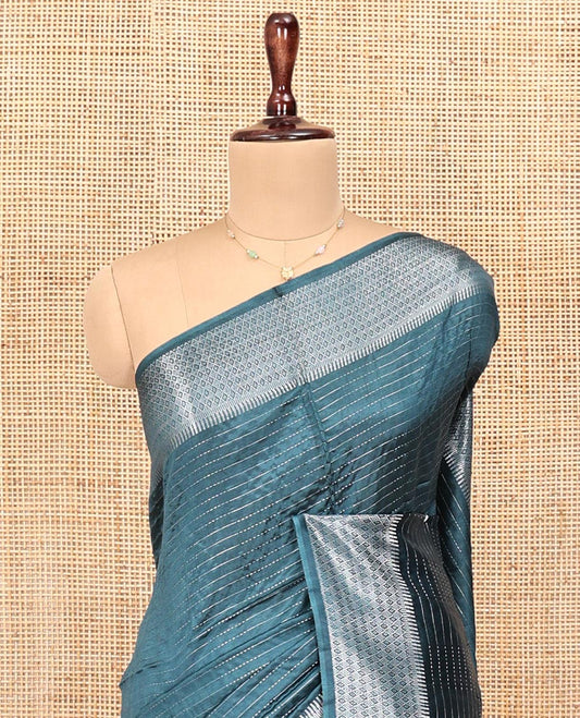 Blue Banana Pith Saree, Detailed with Zari Stripes All Over Its Body, Highlighted by Temple Border of Jaal Designs, Subtly Striped Pallu, and Paired with a Matching Blouse