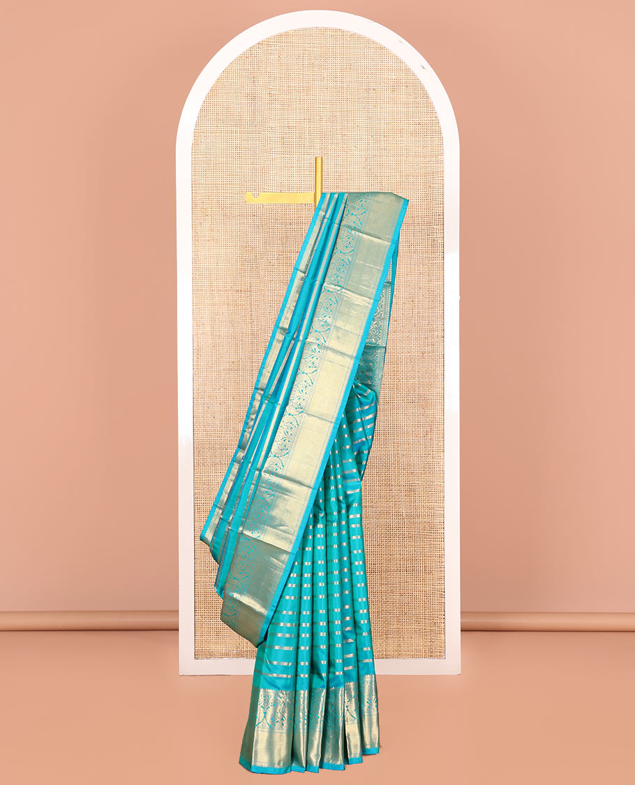 Blue Vasundhara Silk Saree, Gleamed Up with Muthu, and Neli Stripes, Complemented by a Zari Border of Thilakam, Kathir, Mayil, and Jaal Designs, Pallu Depicting Diagonal Stripes, and Paired with a Matching Blouse