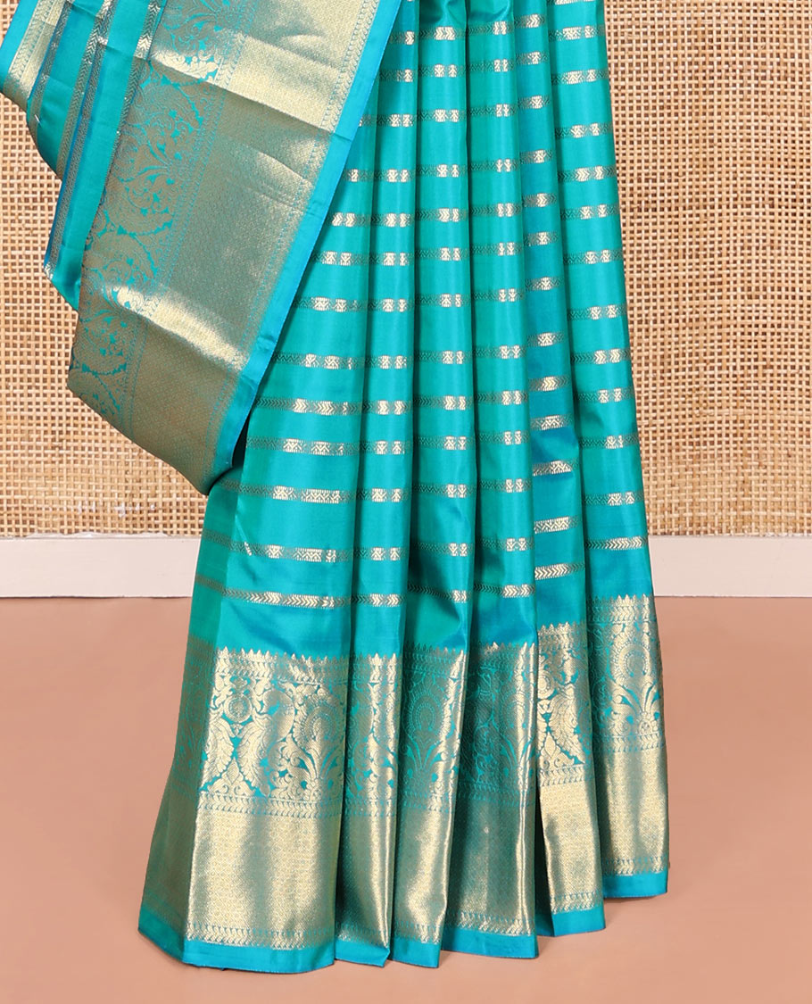 Blue Vasundhara Silk Saree, Gleamed Up with Muthu, and Neli Stripes, Complemented by a Zari Border of Thilakam, Kathir, Mayil, and Jaal Designs, Pallu Depicting Diagonal Stripes, and Paired with a Matching Blouse