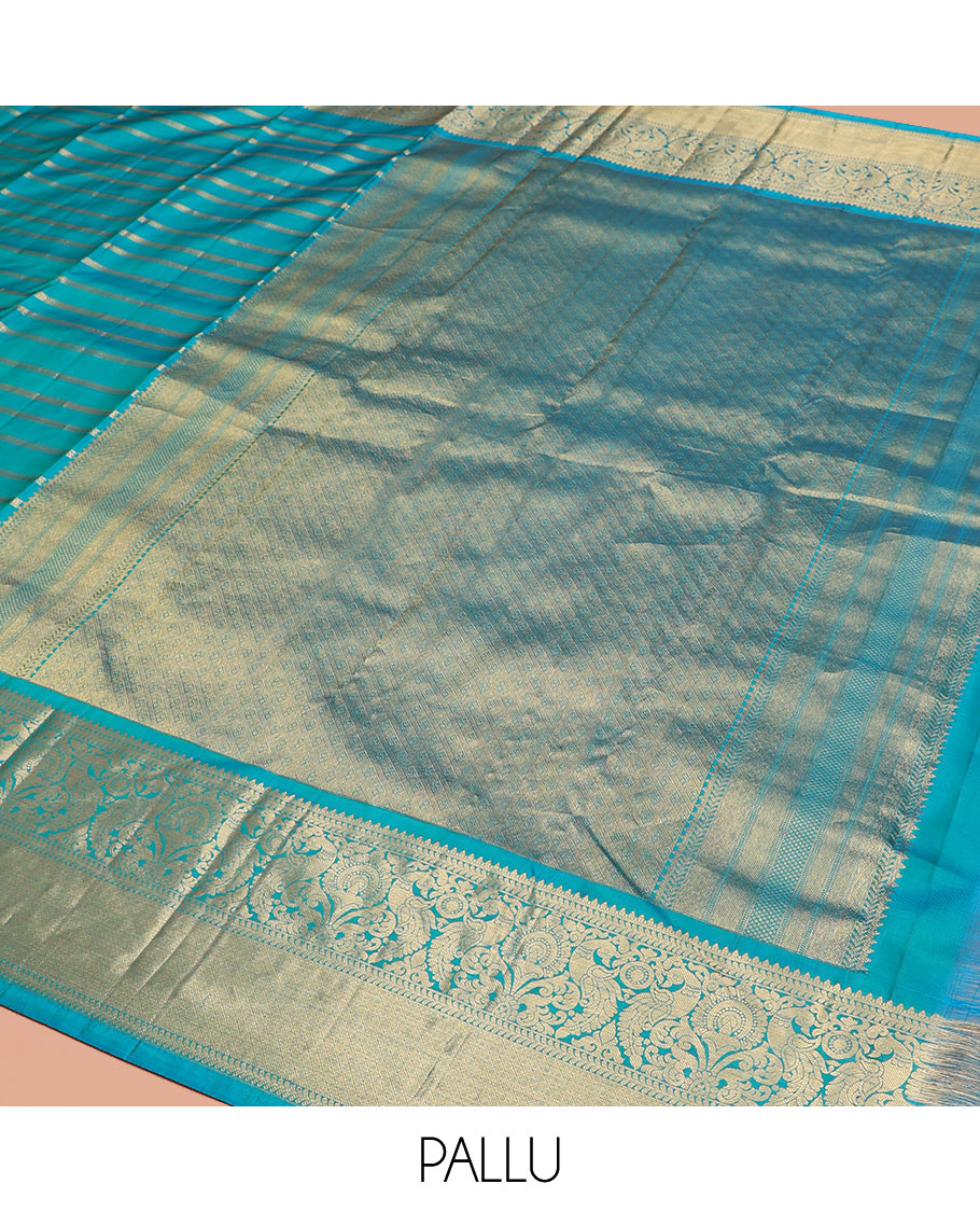 Blue Vasundhara Silk Saree, Gleamed Up with Muthu, and Neli Stripes, Complemented by a Zari Border of Thilakam, Kathir, Mayil, and Jaal Designs, Pallu Depicting Diagonal Stripes, and Paired with a Matching Blouse