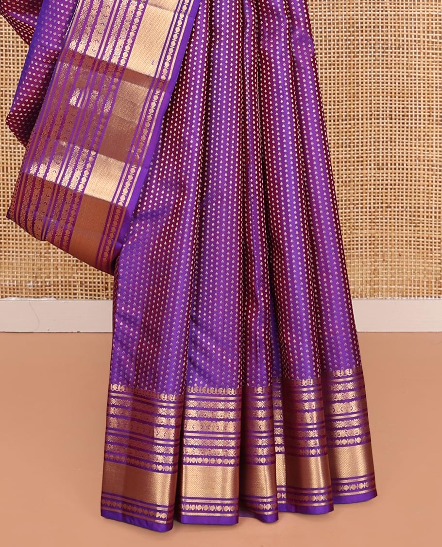 Violet Vasundhara Silk Saree, Gracefully Embellished with Zari Buttas on Its Body, Highlighted by Zari Border of Manga, Cross Kamalam, Jada Nagam, Rudraksham, and Mayil Kann Designs, Grand Jaal Pallu, and Paired with a Matching Blouse