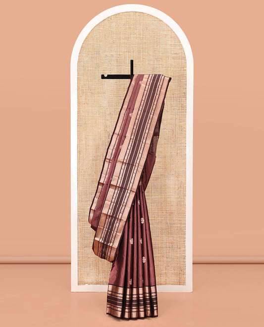 Brown Vasundhara Silk Saree, Detailed with Iruthakshi Buttas All Over Its Body, Complemented by a Contrast Border of Thilakam Mokku, Vanki, Yaanai, and Muthu Designs, Grand Pallu, and Paired with a Contrast Blouse
