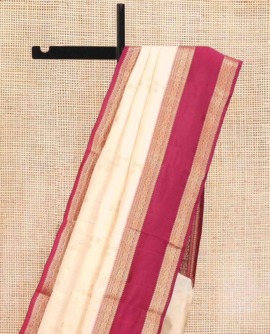Cream Vasundhara Silk Saree, Steeped in Richness of Zari Buttas All Over Its Body, Complemented by a Contrast Rettai Pettu Border of Rekku, Muthu, and Chakram Designs, Grand Pallu, and Paired with a Contrast Blouse