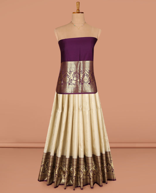Light Sandal Art Silk Pavadai Material Set, Impeccably Styled with Buttas and Checks on Its Skirt, Complemented by a Contrast Mughal-Style Zari Design Woven Border, and Paired with a Contrast Blouse