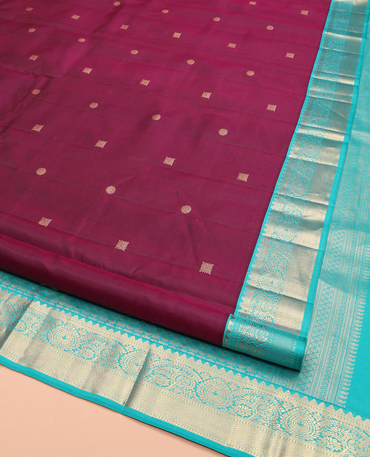 Wine Kanchipuram Silk Saree, Detailed with Zari Buttas on Its Body, Complemented by Contrast Border of Rekku, Muthu, Thilakam, and Mayil Kann Designs, Grandly Woven Pallu, and Paired with a Contrast Blouse