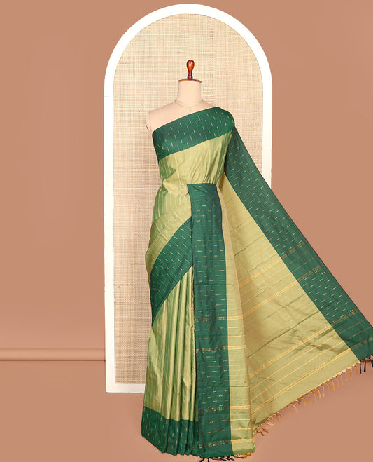 Green Aarani Silk Saree, Lightly Embellished with Zig-Zag Stripes All Over Its Body, Complemented by a Contrast Zari Buttas Border, Pallu of Stripes, and Paired with a Matching Blouse