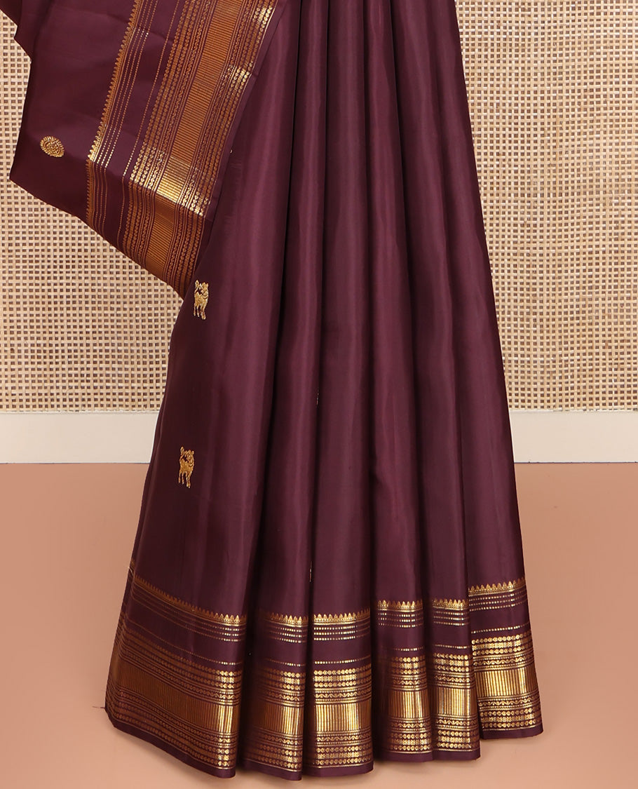 Brown Kanchipuram Silk Saree, Subtly Enriched with Yaali Buttas All Over Its Body, Highlighted by Zari Border of Thilakam, Muthu, Cross Kamalam, and Neli Designs, Grand Pallu, and Paired with a Matching Blouse