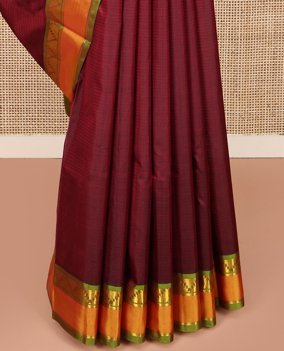 Maroon Kanchipuram Silk Saree, Sparsely Woven with Vazhaipoo Stripes and Buttas on Its Body, Complemented by Contrast Rettai Pettu Border of Thazampoo Rekku, and Kathir Designs, Zari-Striped Pallu, and Paired with a Contrast Blouse