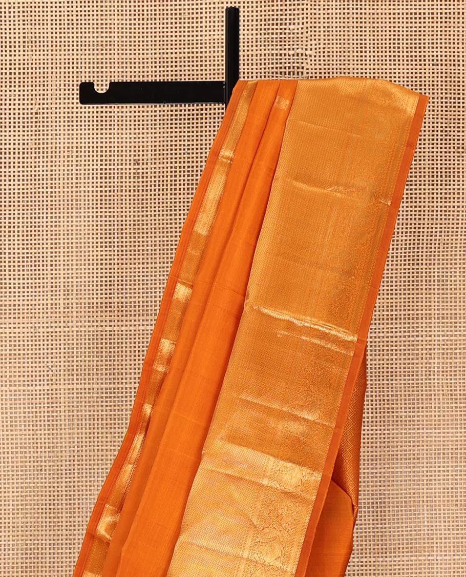 Orange Kanchipuram Silk Saree, Decked Up with Mayil Buttas All Over Its Body, Highlighted by Zari Border of Salngai, Mayil, Yaanai, and Mayil Kann Designs, Subtly Enriched Jaal Pallu, and Paired with a Matching Blouse