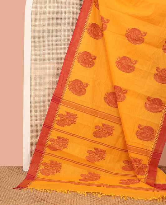 Orange Kanchi Cotton Saree, Beautified with Peacock Buttas All Over Its Body, Complemented by Contrast Border, Pallu Steeped with Flower Vase Designs, and Paired with a Matching Blouse