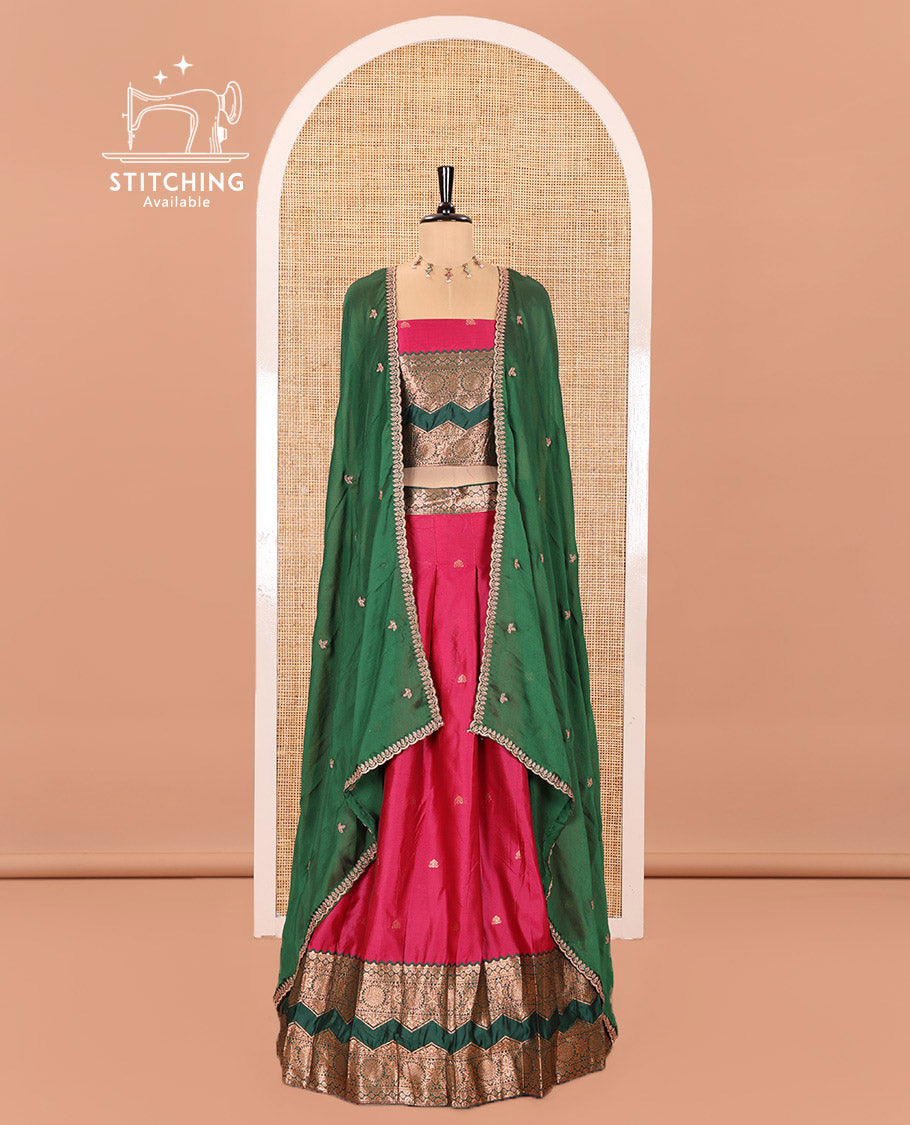Pink and Green Semi-Banarasi Half-Saree Elevated with Zari Buttas on Its Skirt, Complemented by Contrast Traditional Zari Border of Chakram Designs, Paired with a Matching Blouse, and a Satin Georgette Embroidered Scallop Dhavani