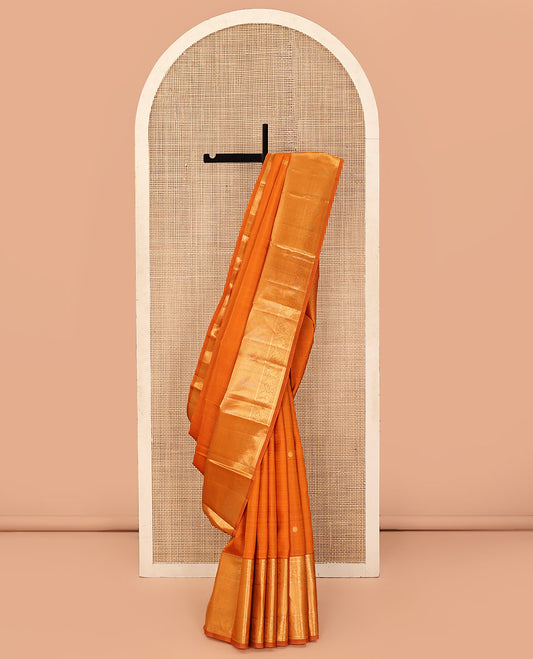 Orange Kanchipuram Silk Saree, Decked Up with Mayil Buttas All Over Its Body, Highlighted by Zari Border of Salngai, Mayil, Yaanai, and Mayil Kann Designs, Subtly Enriched Jaal Pallu, and Paired with a Matching Blouse