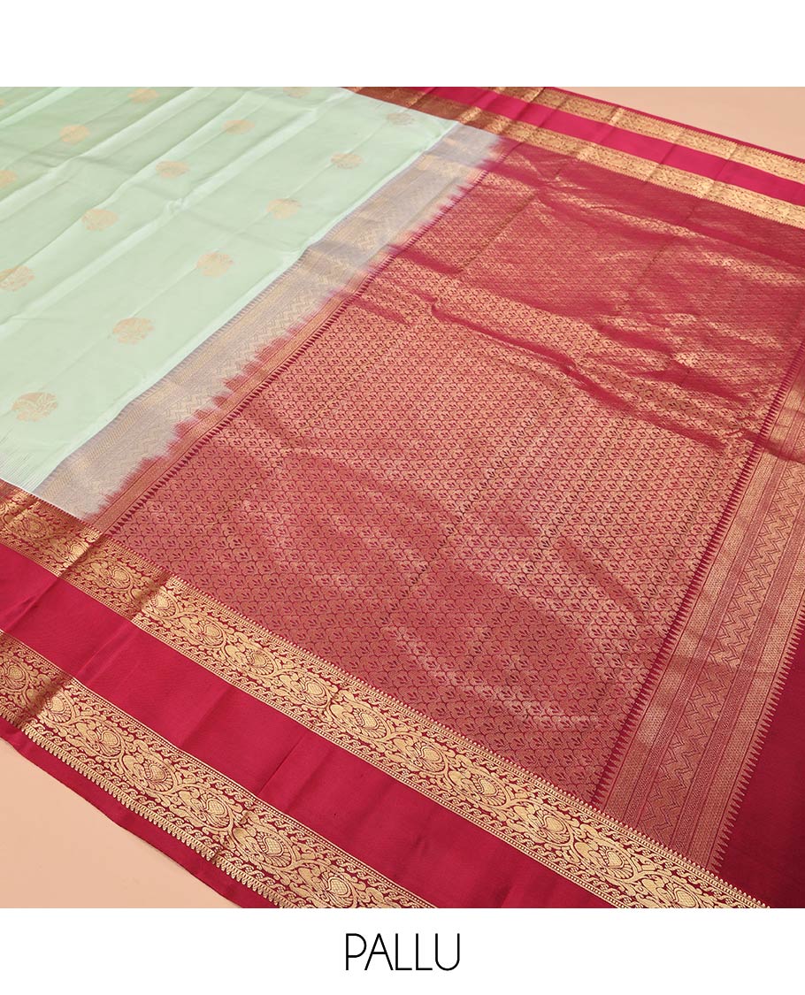 Green Zari Buttas Vasundhara Silk Saree Adorned with a Contrast Rettai Pettu Border of Rekku, Muthu, and Kodi Mayil Designs, Grand Pallu, and a Contrast Blouse