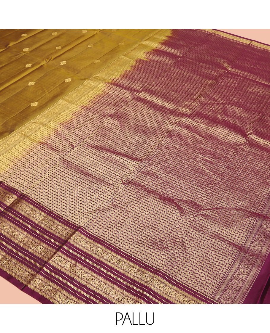 Green Vasundhara Silk Saree, Embellished with Zari Buttas All Over Its Body, Complemented by Contrast Border of Rekku, Muthu, Kathir, And Mayil Designs, Paiyadi Kattam Pallu, and Paired with a Contrast Blouse