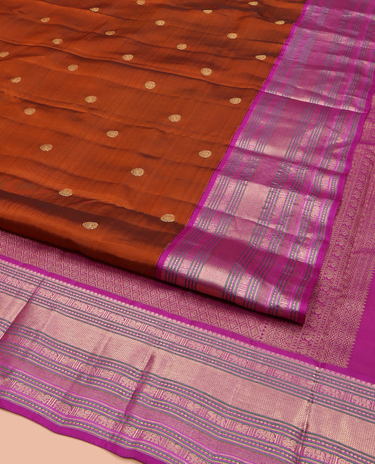 Rust Orange Vasundhara Lite Silk Mix Saree, Showcasing with Zari Buttas, Complemented by a Contrast Border of Thilakam Mokku, Banaras, Mayil, Yaanai, and Mayil Kann Designs, Artfully Detailed Pallu of Jaal Designs, and Paired with a Contrast Blouse
