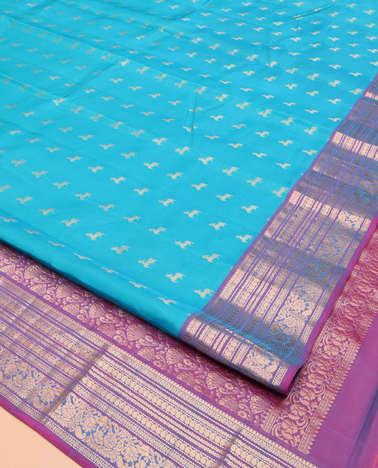 Blue Vasundhara Lite-Silk Mix Saree, Featuring Deer Buttas All Over Its Body, Complemented by a Contrast Border of Thilakam Mokku, Muthu, Kamalam, Neli, Manga, and Kodi Visiry Designs, Opulently Embellished Pallu, and Paired with a Contrast Blouse