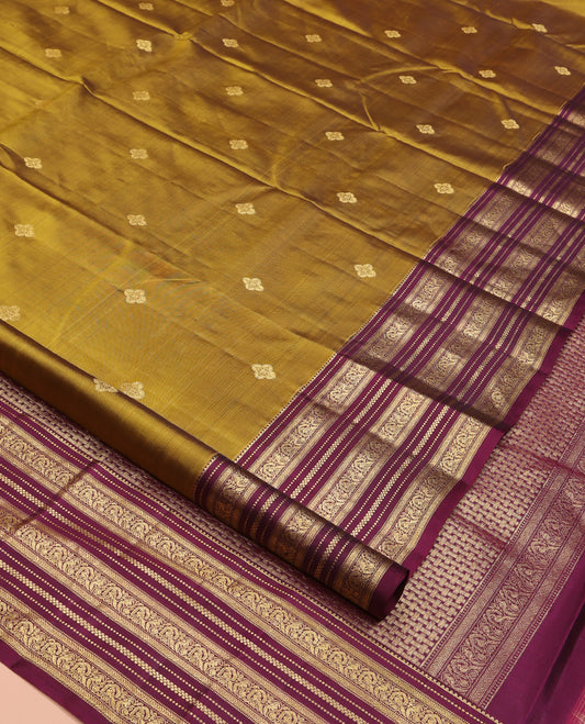 Green Vasundhara Silk Saree, Embellished with Zari Buttas All Over Its Body, Complemented by Contrast Border of Rekku, Muthu, Kathir, And Mayil Designs, Paiyadi Kattam Pallu, and Paired with a Contrast Blouse