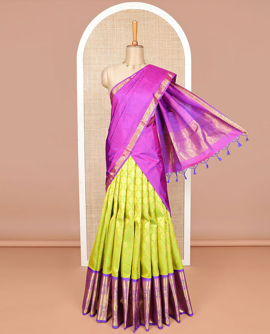 Green buttas silk half saree with contrast border of thilakam mokku, banaras, poo chkram, mayil design, zari design blouse & zari design border dhavani