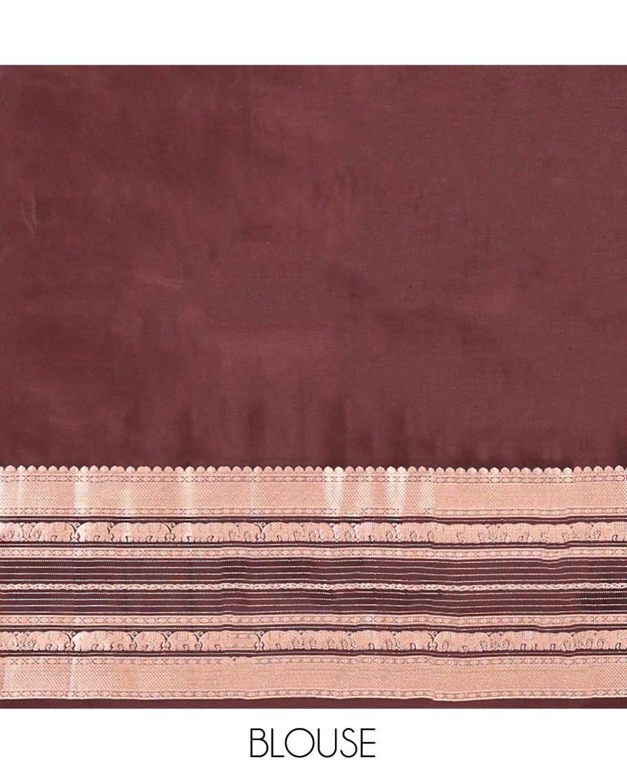 Brown Vasundhara Silk Saree, Detailed with Iruthakshi Buttas All Over Its Body, Complemented by a Contrast Border of Thilakam Mokku, Vanki, Yaanai, and Muthu Designs, Grand Pallu, and Paired with a Contrast Blouse