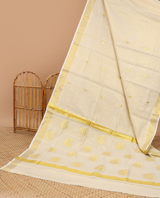Cream kerala saree with zari buttas, plain border & pallu of traditional zari designs