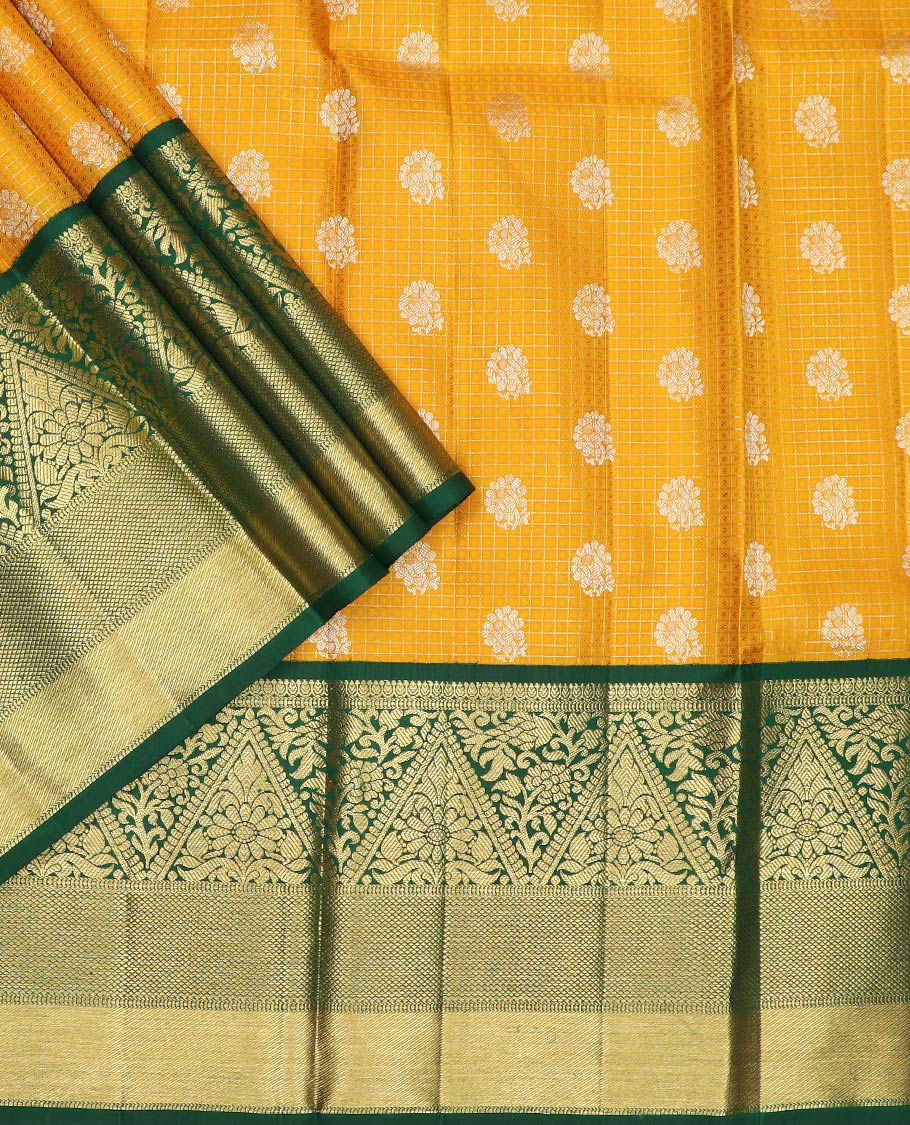 Yellow pure-silk half-saree with buttas, checks, and embossed design skirt, contrast traditional kanchi border, contrast zari design blouse, and a manga motifs woven dhavani