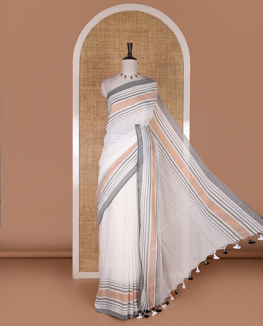 Cream-grey plain design mul mul cotton saree, contrast copper zari horizontally striped border, plain pallu, and plain blouse