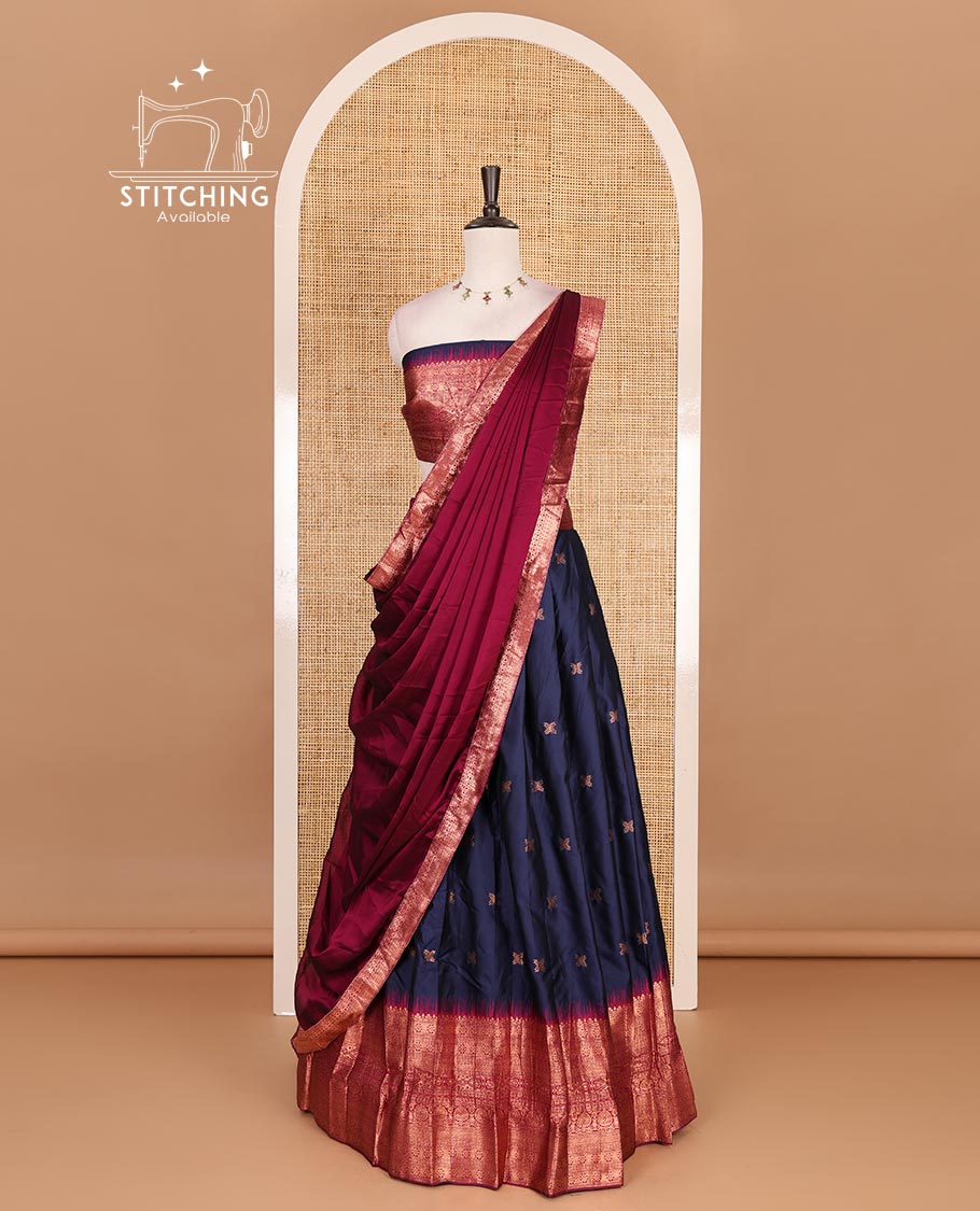Dark blue taffeta silk half saree, floral zari buttas with contrast green traditional zari border, matching zari blouse, and contrast plain zari border dhavani