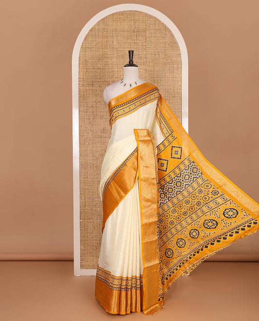 Cream-mustard zari striped dola silk saree, contrast traditional zari border of leaf creeper, Ajrakh printed pallu, and Ajrakh printed blouse