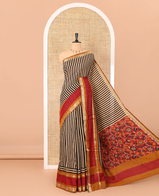Black vertically striped muslin silk saree, contrast zari rettai pettu border, kalamkari floral vine printed pallu, and a contrast plain blouse