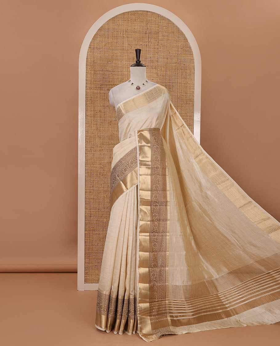 Cream plain tussar saree, traditional zari design border, pallu of zari stripes & matching traditional motif border blouse