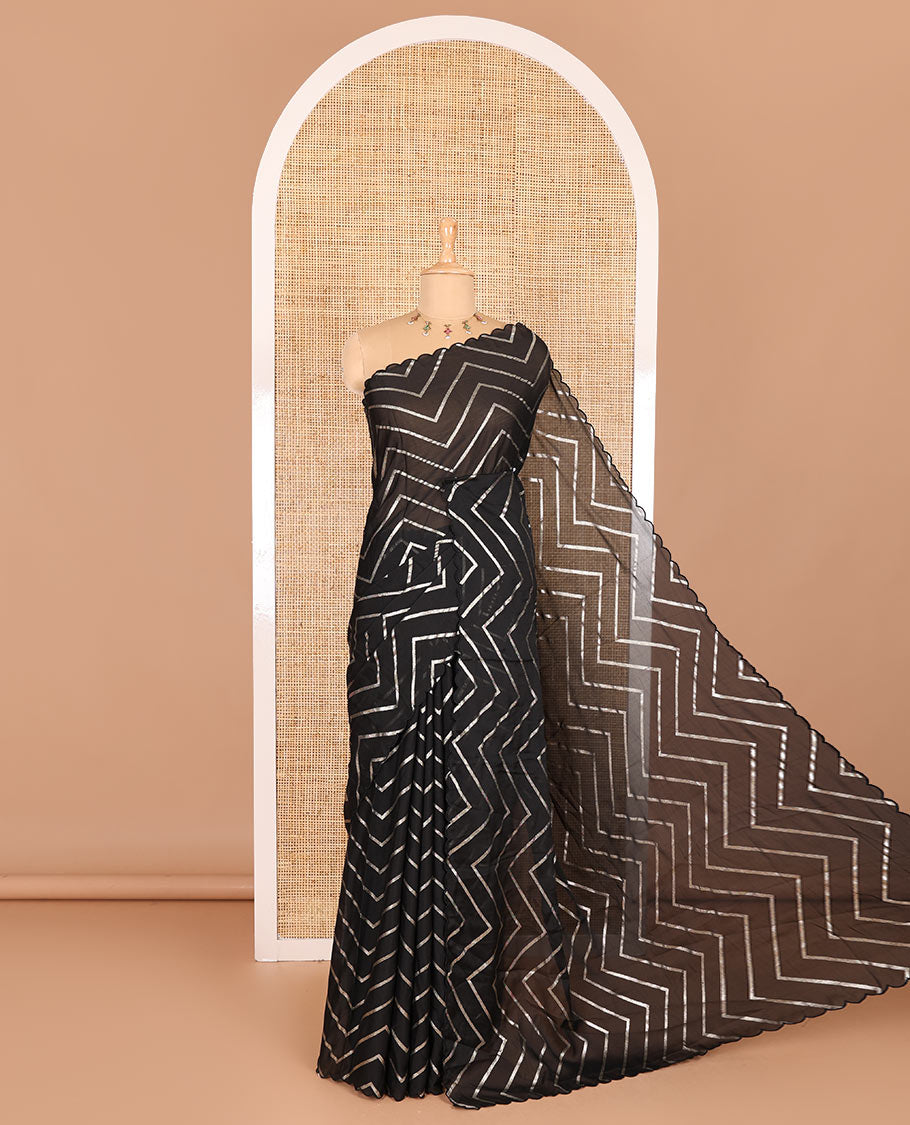 Borderless black zig-zag stripes gold foil printed, scallop-edged rangoli chiffon saree with a matching bandhani dotted blouse