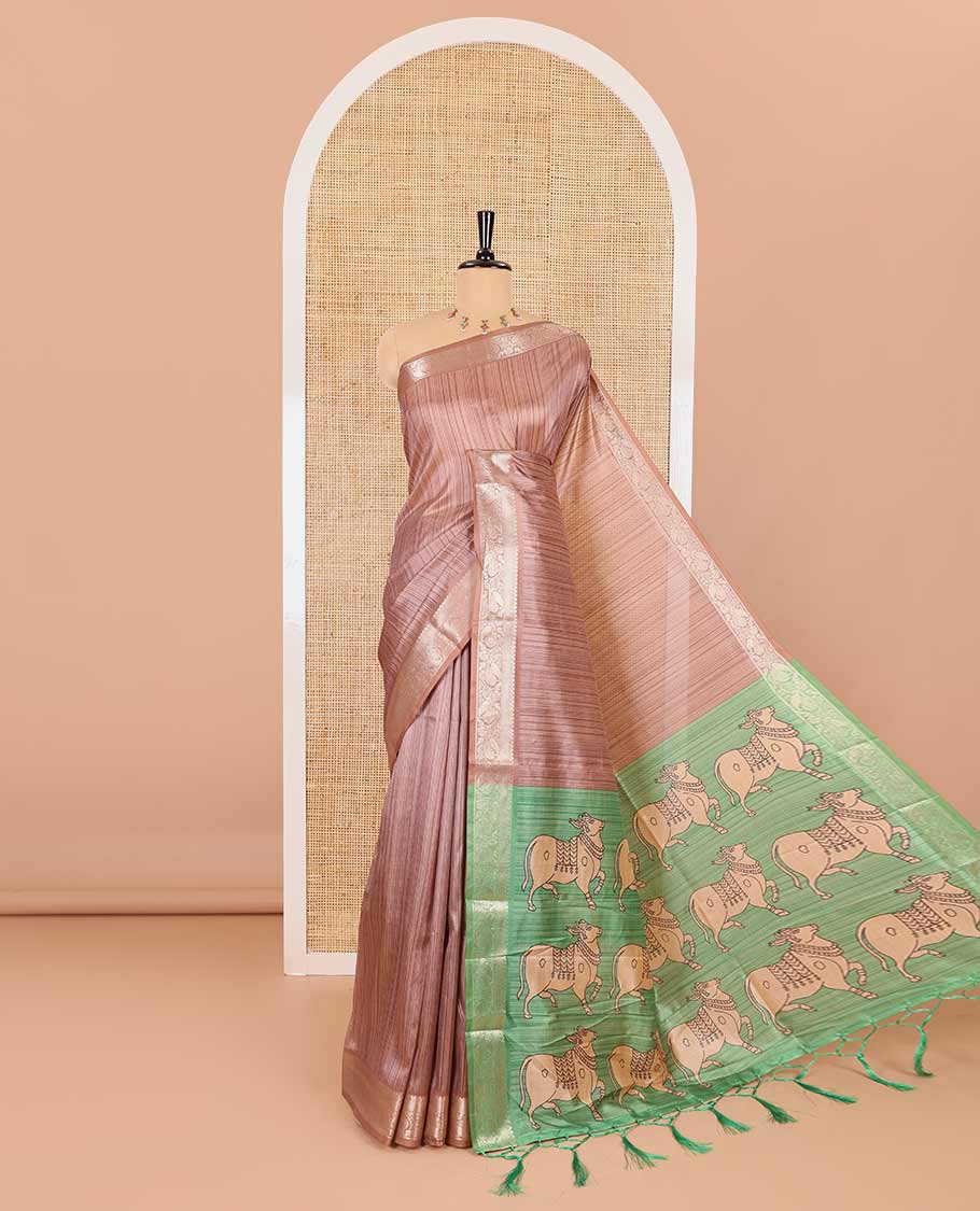 Brown striped semi-tussar saree, traditional zari border of floral creeper designs, contrast pallu of Pichwai cow print, and contrast Pichwai cow printed blouse