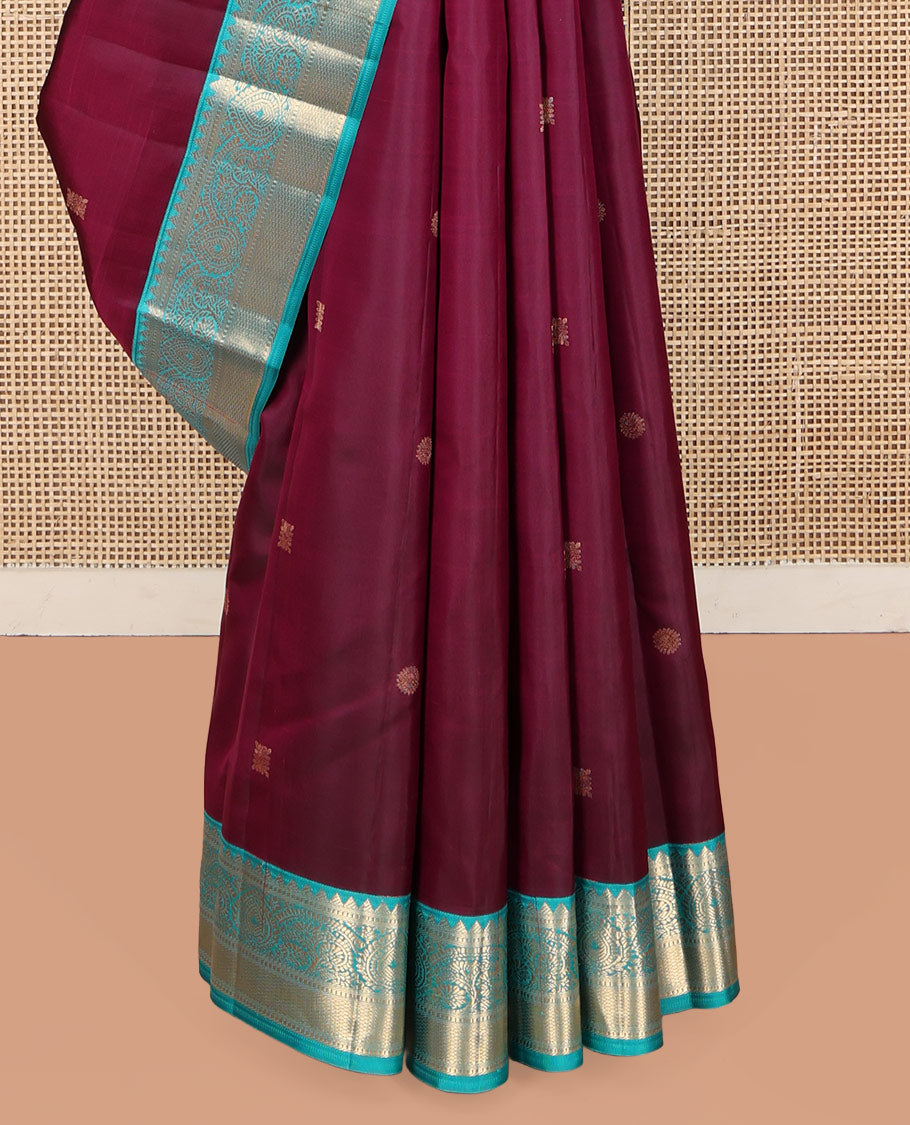 Wine Kanchipuram Silk Saree, Detailed with Zari Buttas on Its Body, Complemented by Contrast Border of Rekku, Muthu, Thilakam, and Mayil Kann Designs, Grandly Woven Pallu, and Paired with a Contrast Blouse