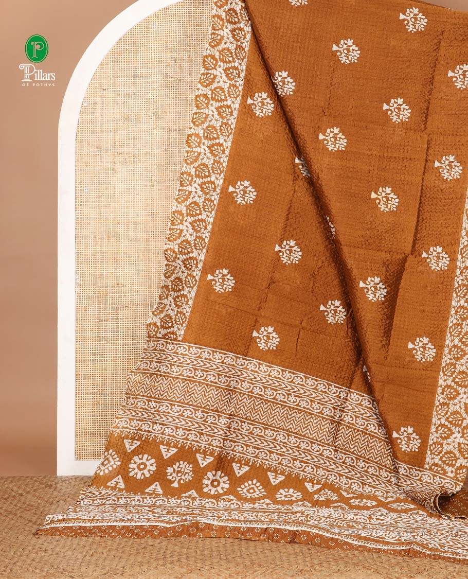 Gold batik-style tree motif printed litch crushed saree, leaf print border, floral-geometric print pallu & floral print blouse