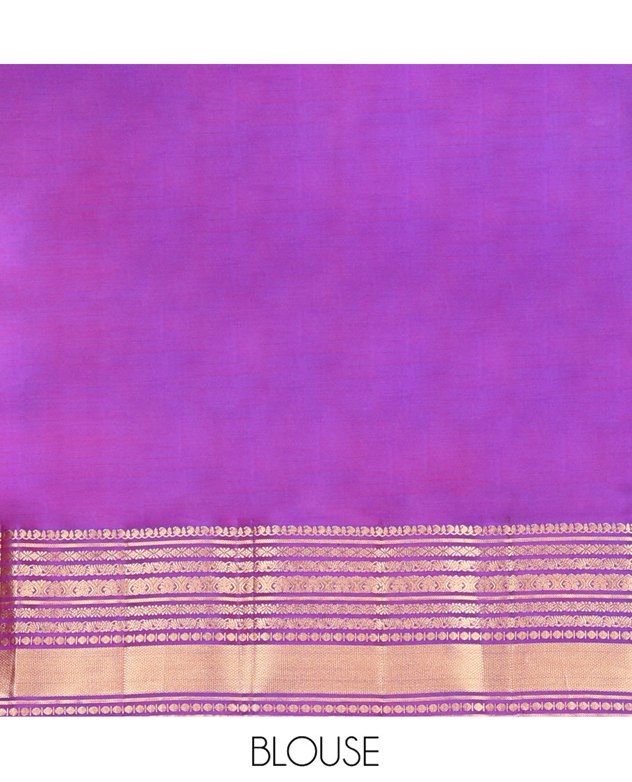 Violet Vasundhara Silk Saree, Gracefully Embellished with Zari Buttas on Its Body, Highlighted by Zari Border of Manga, Cross Kamalam, Jada Nagam, Rudraksham, and Mayil Kann Designs, Grand Jaal Pallu, and Paired with a Matching Blouse