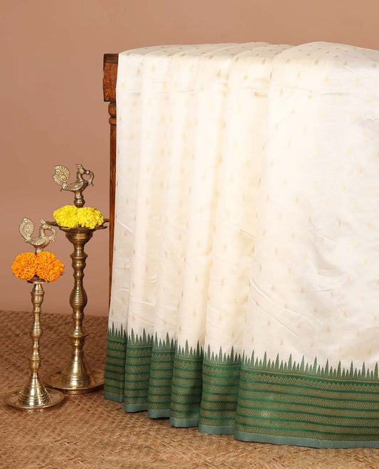 Cream with green temple butta kanchi silk saree with temple, traditional zari border & rich weaving pallu along with butta design blouse