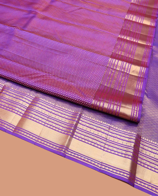Violet Vasundhara Silk Saree, Gracefully Embellished with Zari Buttas on Its Body, Highlighted by Zari Border of Manga, Cross Kamalam, Jada Nagam, Rudraksham, and Mayil Kann Designs, Grand Jaal Pallu, and Paired with a Matching Blouse