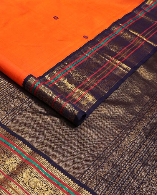 Orange annam chakram buttas Kanchipuram korvai silk saree, contrast rettai pettu korvai border of rekku, banaras, muthu, and chakram designs, and poun design steeped pallu