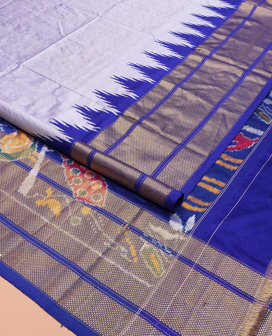 Grey Plain Ikkat Silk Saree, Complemented by a Contrast Temple Border of Diamond Designs, Pallu Features Ikkat Fauna Designs, and Paired with a Contrast Blouse
