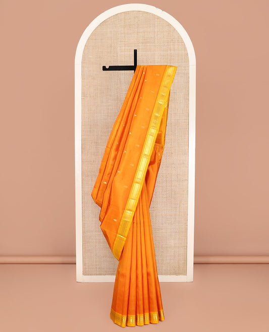 Orange Kanchipuram Silk Saree, Bedecked with Zari Buttas on Its Body, Complemented by a Contrast Zari One-Sided Border of Banaras, and Jaal Designs, Pallu of Zari Designs, and Comes Without a Blouse