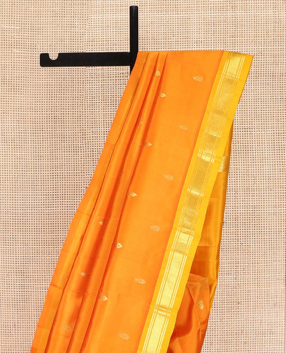 Orange Kanchipuram Silk Saree, Bedecked with Zari Buttas on Its Body, Complemented by a Contrast Zari One-Sided Border of Banaras, and Jaal Designs, Pallu of Zari Designs, and Comes Without a Blouse