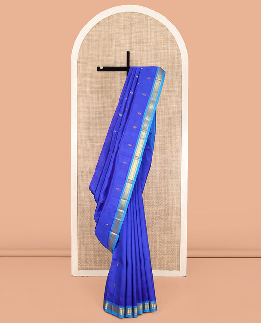 Blue Kanchipuram Silk Saree, Subtly Enriched with Zari Buttas on Its Body, Complemented by a Contrast One-Sided Border of Banaras, and Jaal Designs, Pallu of Zari Designs, and Comes Without a Blouse