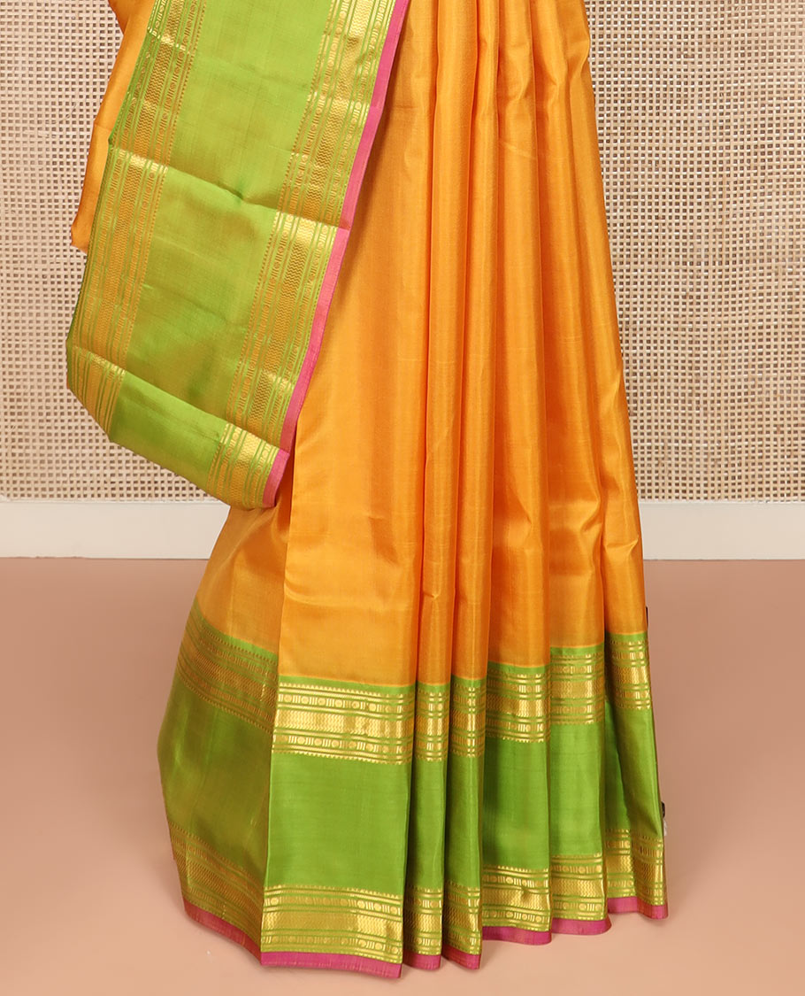Orange Plain Kanchipuram Silk Saree Accentuated by a Contrast Rettai Pettu Border Featuring Rekku, Banaras, Rudraksham, and Vanki Designs, with a Subtly Zari-Woven Pallu, Paired with a Contrast Blouse