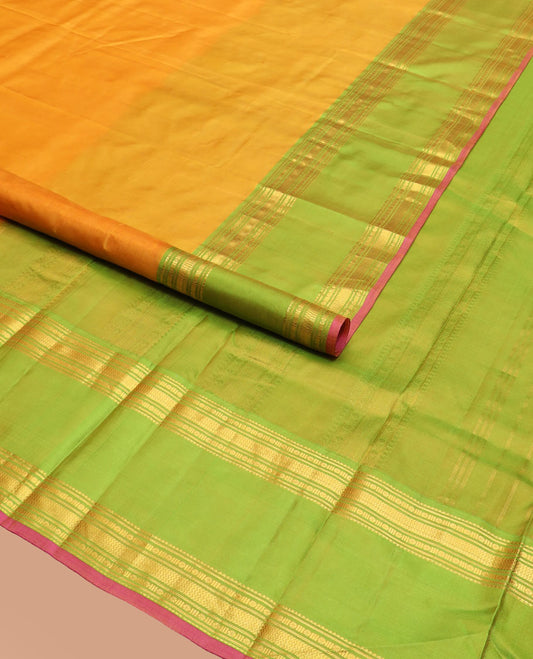 Orange Plain Kanchipuram Silk Saree Accentuated by a Contrast Rettai Pettu Border Featuring Rekku, Banaras, Rudraksham, and Vanki Designs, with a Subtly Zari-Woven Pallu, Paired with a Contrast Blouse
