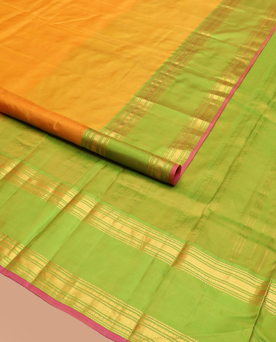 Orange Plain Kanchipuram Silk Saree Accentuated by a Contrast Rettai Pettu Border Featuring Rekku, Banaras, Rudraksham, and Vanki Designs, with a Subtly Zari-Woven Pallu, Paired with a Contrast Blouse