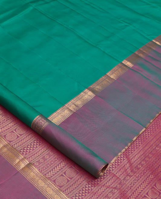 Green plain Kanchipuram silk saree, contrast ganga jamuna rettai pettu border of rekku, neli, banaras, and rudraksham designs, and pallu of kathir, rudraksham, neli, poun, ara bogudi, and ara maadam