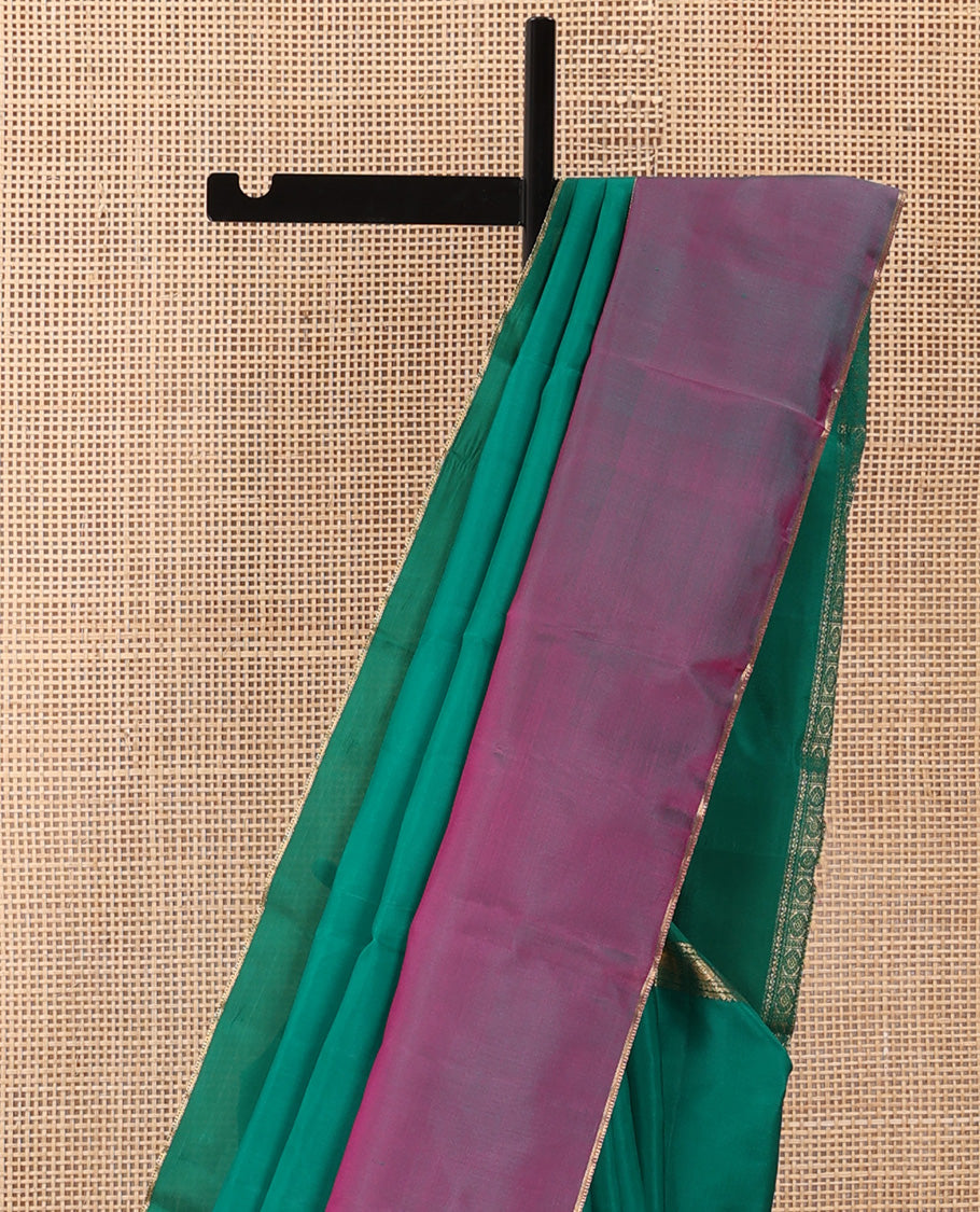 Green plain Kanchipuram silk saree, contrast ganga jamuna rettai pettu border of rekku, neli, banaras, and rudraksham designs, and pallu of kathir, rudraksham, neli, poun, ara bogudi, and ara maadam