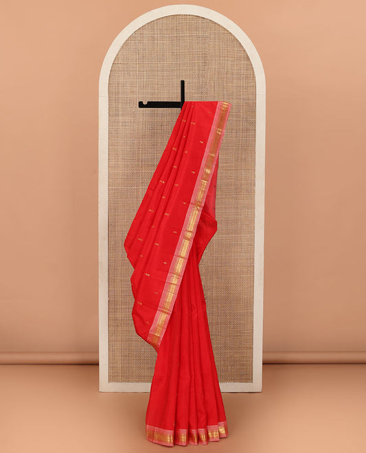 Red Kanchipuram Silk Saree, Accentuated with Zari Buttas All Over Its Body, Complemented by Contrast One-Sided Border of Rekku, Banaras, and Mayil Kann Designs, Pallu of Zari Designs, and Comes Without a Blouse
