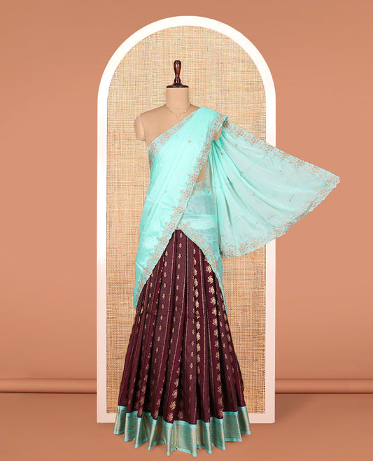 Brown Art Silk Material Half Saree Set, Delicately Woven with Zari Buttas and Stripes on Its Skirt, Complemented by Contrast Traditional Zari Design Border, Paired with a Contrast Blouse, and an Scallop Embroidered Dhavani
